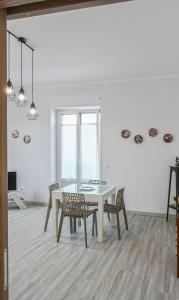 a dining room with a white table and chairs at Il rifugio di eva in Alberobello