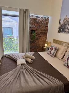a bedroom with a large bed with two towels on it at Duomo View Apartment in Catania