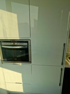 a kitchen with white cabinets and an oven at Sj라벨라 강서 in Samgong