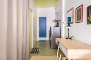 a kitchen with a refrigerator in the middle of a room at Bang Chak 1 Bedroom apartment in Bangkok