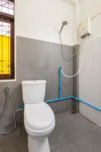 a bathroom with a white toilet and a shower at Bang Chak 1 Bedroom apartment in Bangkok +7 photos