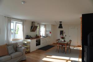 a kitchen and living room with a table and a couch at Lerchenhof in Balingen
