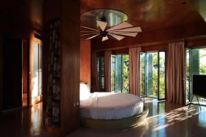 a bedroom with a bed and a ceiling fan at Rooms Hotel Batumi in Batumi