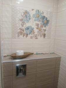 a bathroom with a toilet paper dispenser and a painting at Studio ONE in Kiten +22 photos