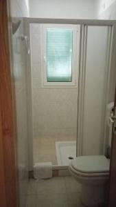 a bathroom with a toilet and a window at L'Oasi del Rossese in Dolceacqua +56 photos