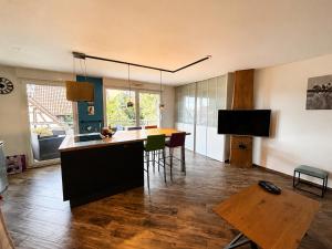 a living room with a kitchen and a dining room at A Chatenois le Repère d'Anna in Châtenois