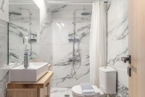 a bathroom with a shower and a sink and a toilet at Ionian Home in Exanthia +14 photos