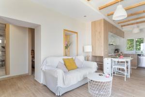 a living room with a white couch and a table at Ionian Home in Exanthia