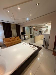 a large bedroom with a large bed and a couch at Venis House in Plovdiv