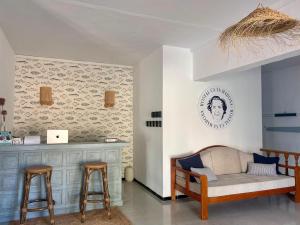 a living room with a couch and two bar stools at Ca sa Madona Hostal in Paguera
