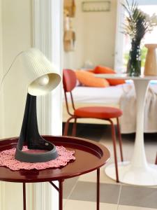 a room with a table with a lamp and chairs at Blue Loft 360 in Patra +15 photos