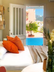 a couch with orange pillows in a living room at Blue Loft 360 in Patra