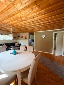 a dining room with a white table and wooden ceilings at Camp Caroli Olala in Jukkasjärvi