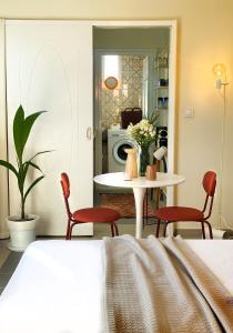 a dining room with a table and red chairs at Blue Loft 360 in Patra