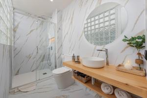a bathroom with a toilet and a sink and a shower at Apartment Vistamar IV in Port de Pollensa +14 photos
