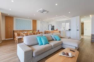a living room with a couch and a kitchen at Apartment Vistamar IV in Port de Pollensa