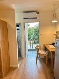 a kitchen with a table and a chair and a dining room at O2 Bangsaen in Ban Bang Saen (1) +9 photos