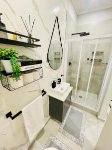 a white bathroom with a sink and a mirror at Cozy and Warm-Private Queen Bedroom with Private Bathroom & shared Kitchen& Lounge in Parklands +6 photos