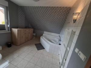 a bathroom with a bath tub and a sink at Dixi-Land in Tauche +11 photos