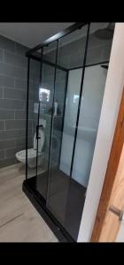 a glass shower in a bathroom with a toilet at Chez JP & NATH in Alcossebre