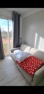 a room with a couch with a red blanket on it at Chez JP & NATH in Alcossebre