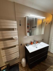 a bathroom with a sink and a mirror at A Chatenois le Repère d'Anna in Châtenois +22 photos