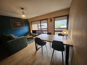 a living room with a dining room table and chairs at Le Haut du Rosay in Sallanches