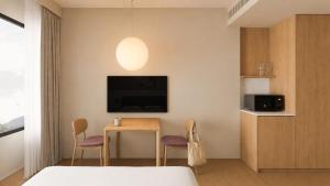 a bedroom with a table and two chairs and a tv at Stey Stavanger in Stavanger +6 photos