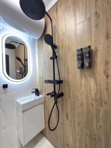 a bathroom with a shower and a sink and a mirror at Top Centre Apartment 5 mins to beach in Burgas