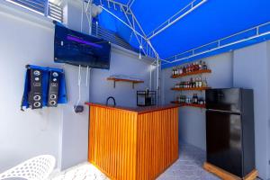 a bar with an orange counter and a tv in a room at Akibo Residency Apartment in Mwanza