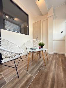 a living room with a table and chairs at Top Centre Apartment 5 mins to beach in Burgas