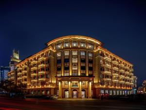 a large building is lit up at night at Xiamen Lujiang Harbourview Hotel-panoramic sea views over Gulangyu in Xiamen