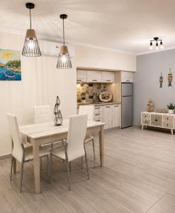 a kitchen and dining room with a table and chairs at Sea breeze 2 in Limenaria