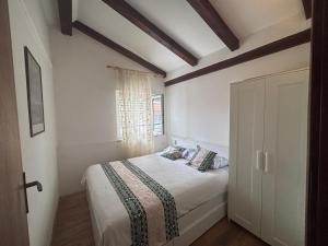 a bedroom with a bed and a window at Apartments Tajana in Novigrad Istria