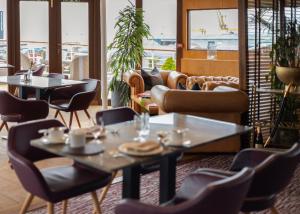 a restaurant with couches and tables and chairs at Fingal Hotel in Edinburgh