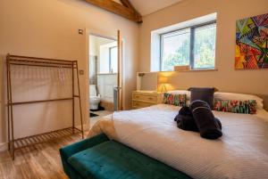 a bedroom with two beds and a mirror at Lynwood Barn - Barn Conversion in Midsomer Norton, Parking & Dog Friendly in Radstock