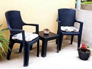 two black chairs and a table on a patio at Stan na dan Flora Nevesinje in Nevesinje