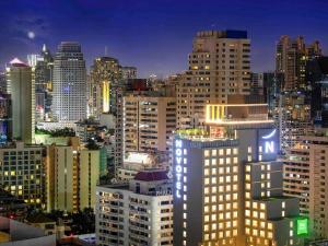 a view of a city skyline at night at ibis Styles Bangkok Sukhumvit 4 in Bangkok