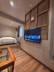 a bedroom with a bed and a flat screen tv on a wall at Chez André in Cognac +2 photos