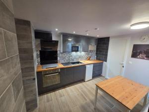 a kitchen with a wooden table and a counter top at Chez André in Cognac