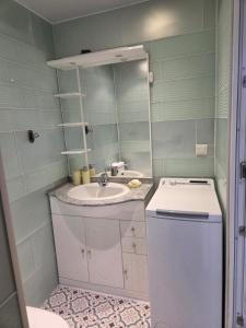 a small bathroom with a sink and a mirror at Chez André in Cognac