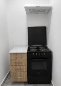 a kitchen with a black stove and a counter at Gorica in Negotin +18 photos