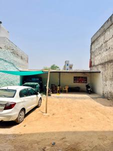 a white car parked in front of a garage at Shri brijwasi palace in Vrindāvan