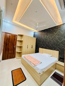 a bedroom with a bed in a room with a ceiling at Shri brijwasi palace in Vrindāvan +4 photos