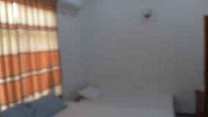 a hallway of a building with an orange and white wall at Bhaavi Guest Inn in Jaffna