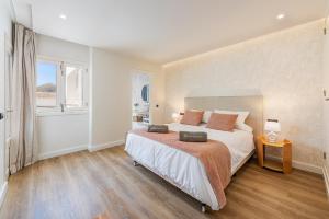 a bedroom with a large bed and a window at Apartment Vistamar III in Port de Pollensa