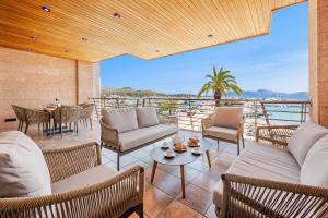 a patio with furniture and a view of the ocean at Apartment Vistamar III in Port de Pollensa