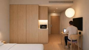 a man sitting at a desk in a hotel room at Stey Stavanger in Stavanger