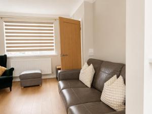 a living room with a couch and a window at Llantarnam House by Tŷ SA in Cardiff +6 photos