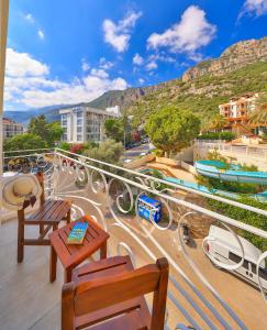 a balcony with tables and chairs and a ride at Arnna Hotel in Kaş